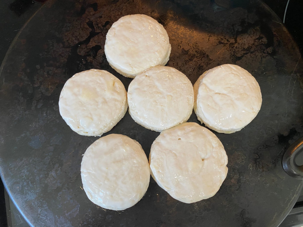 Raw biscuits on a baking stone, ready for the oven. [buttermilk biscuits]