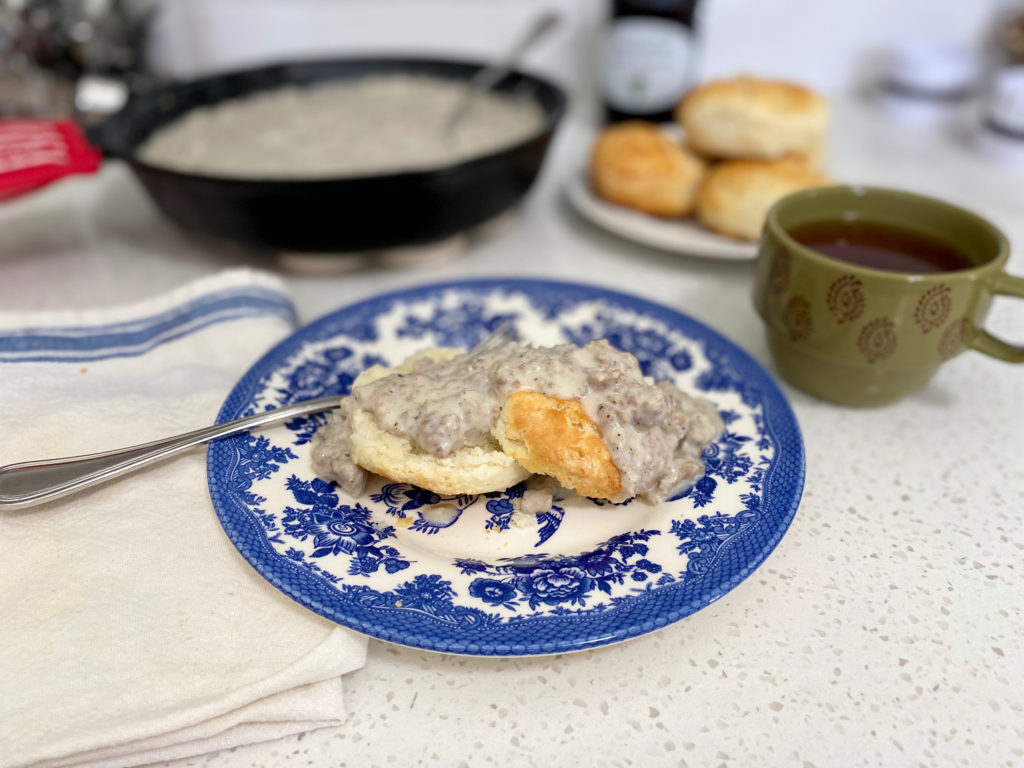 A plate of sausage gravy and biscuits. [buttermilk biscuits]