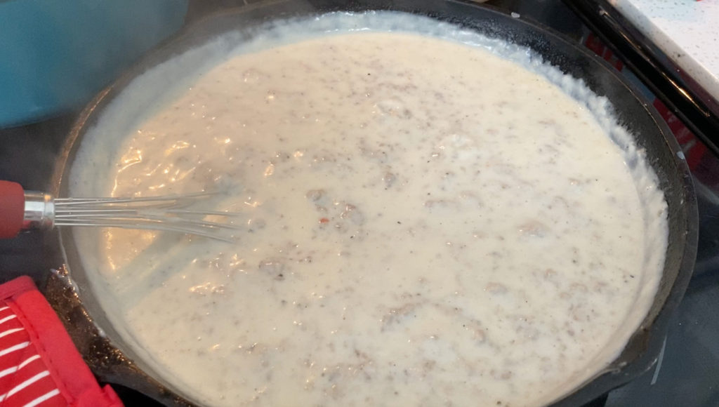 The cooked gravy in a cast iron skillet, ready to serve the biscuits and gravy. [biscuits and gravy]