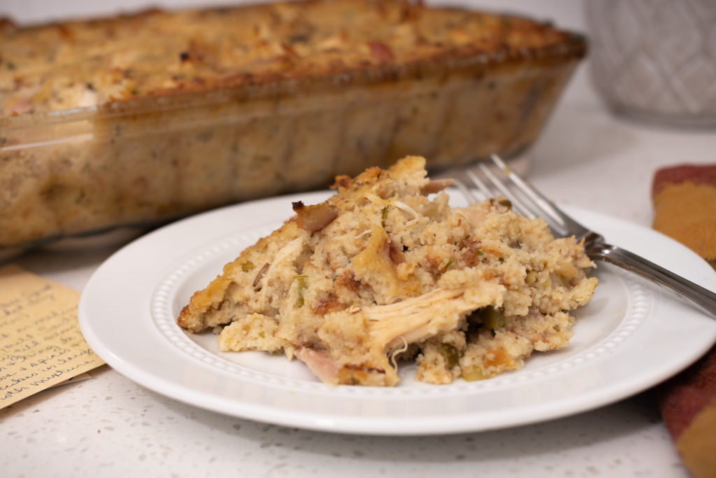 A plate of chicken and dressing with a fork and a recipe card. [Chicken and Dressing]