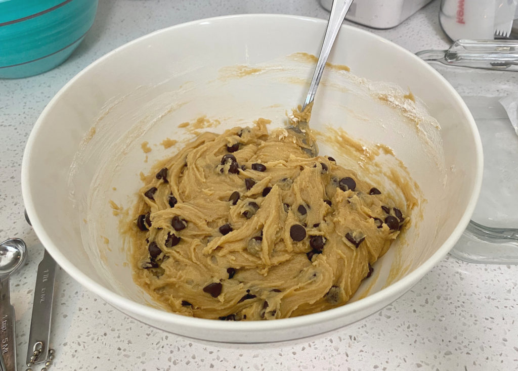 A bowl filled with raw cookie bar batter [chocolate chip cookie bars]