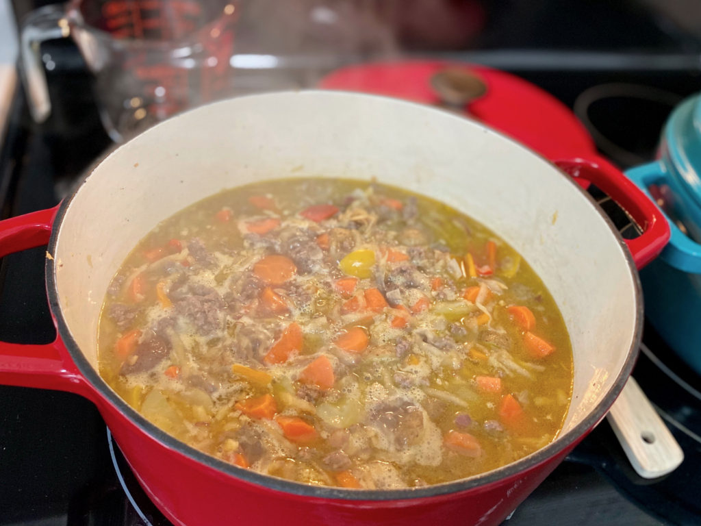 Simmering ingredients for Japanese Curry in dutch oven