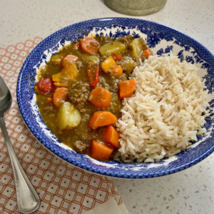 A bowl of Japanese Curry with chicken and rice.