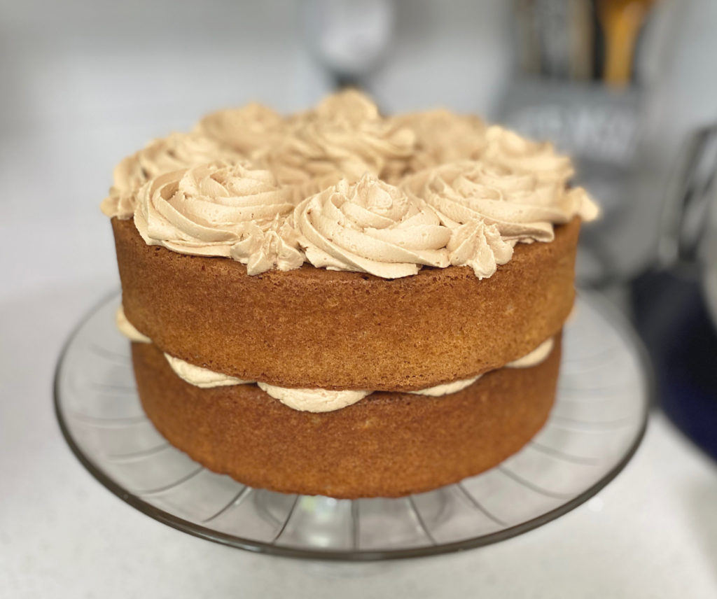 Two cake layers with biscoff buttercream in the middle and piped on top. [biscoff cake]