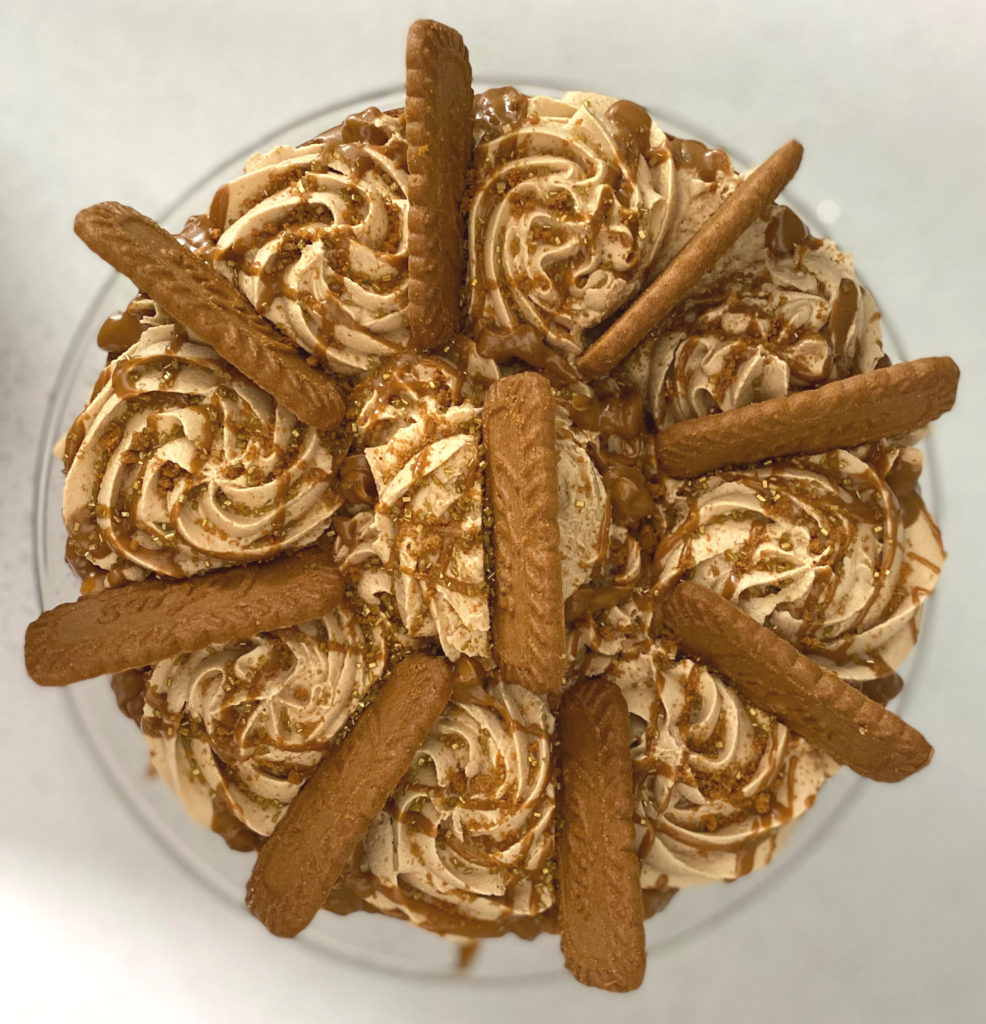 Top view of Biscoff Cake decorated with biscoff cookies and drizzled with biscoff cookie butter. [biscoff cake