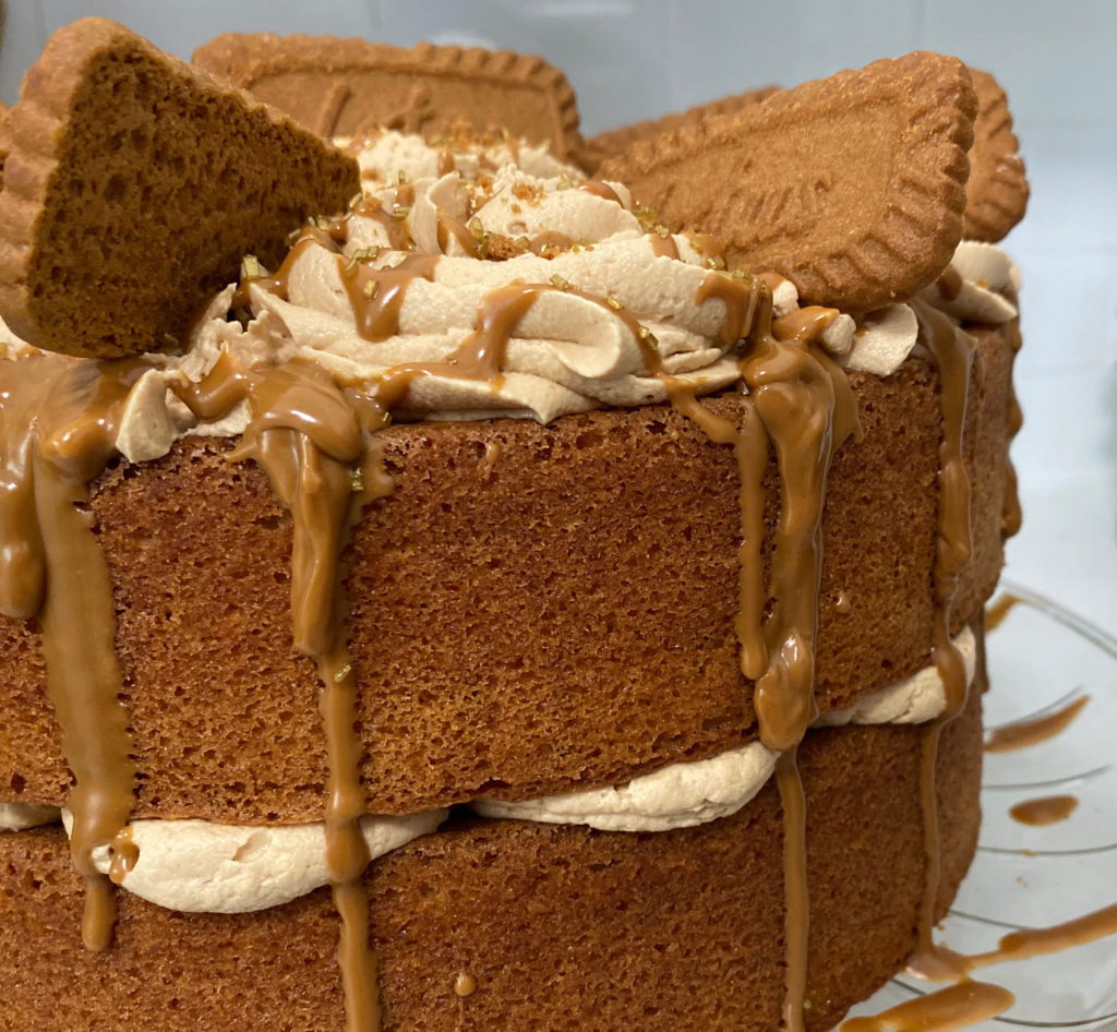 Close up side view of biscoff cake with biscoff butter drizzled down the side. [biscoff cake]