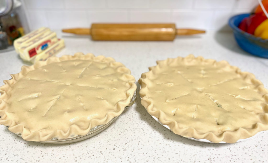 Two uncooked chicken pot pies on the counter, ready to go into the oven. [Classic Chicken Pot Pie]