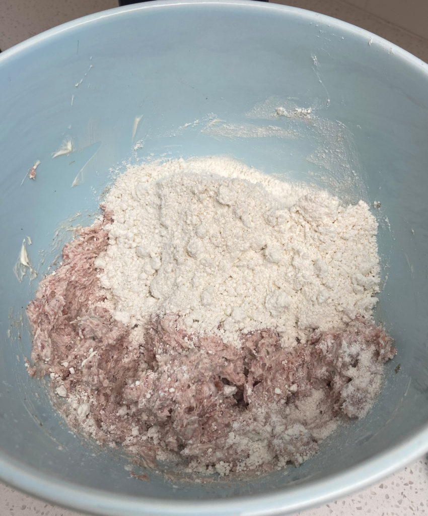 Sausage and cream cheese mixture with bisquick in mixing bowl