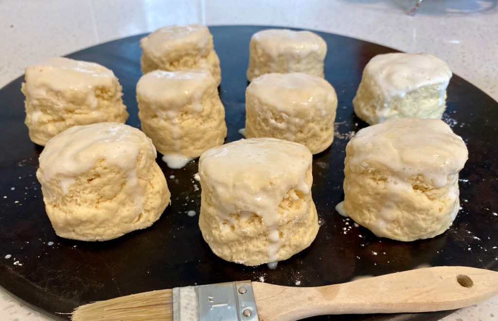 Brushing milk on top of classic scones