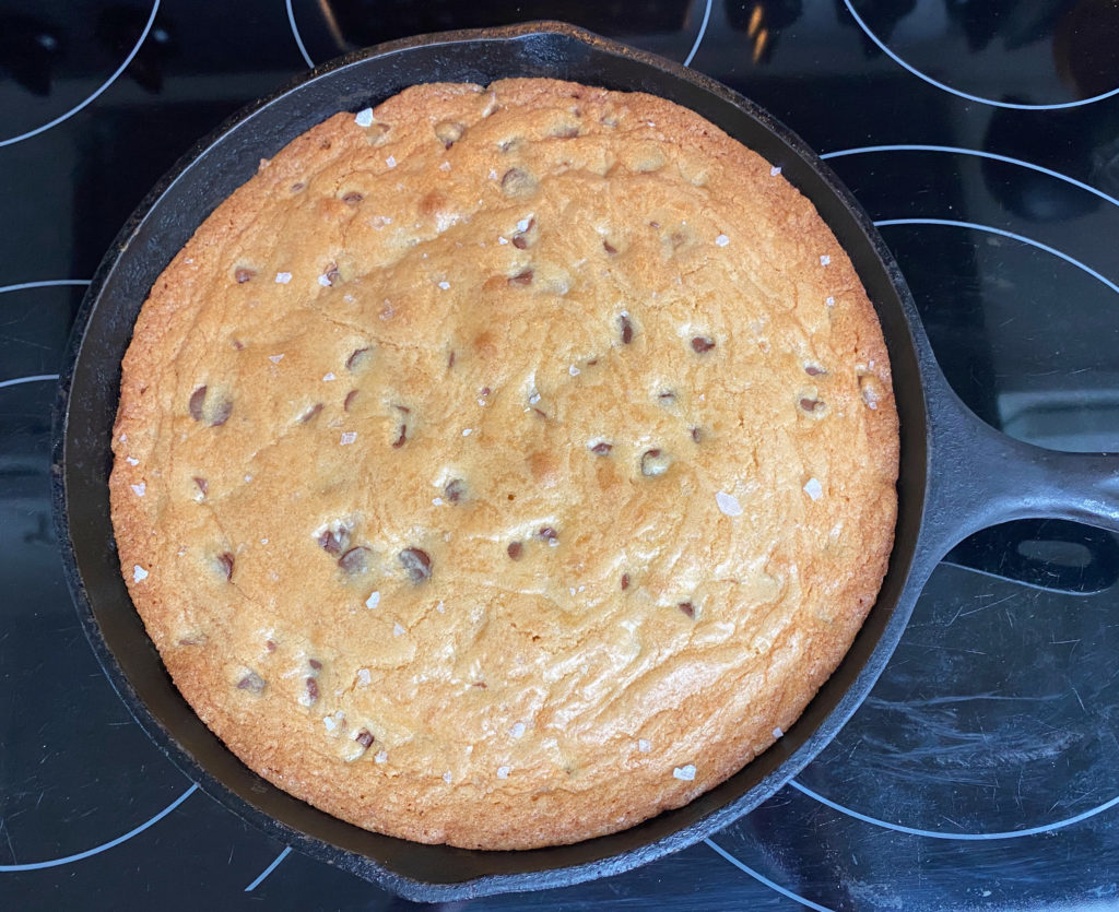 Baked chocolate chip skillet cookie in cast iron skillet