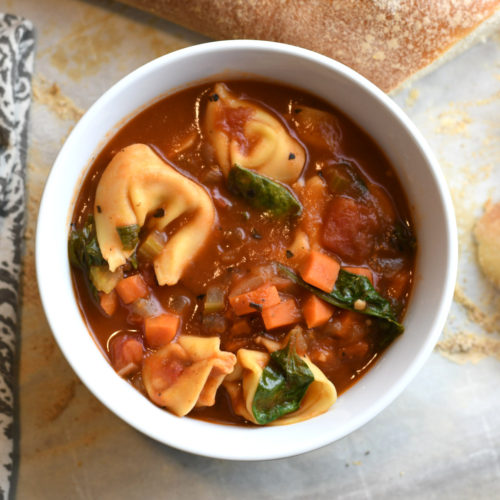 A bowl of tortellini soup.